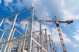 A building site with a red crane