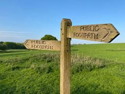 A public footpath sign in the countryside