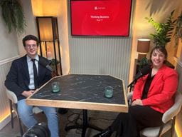 Rupert and Charlotte sitting in a podcast studio