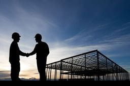 Two silhouettes shaking hands