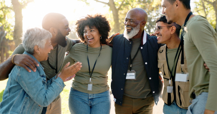 A group of charity workers smiling and embracing