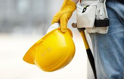 Construction worker holding hat to the side