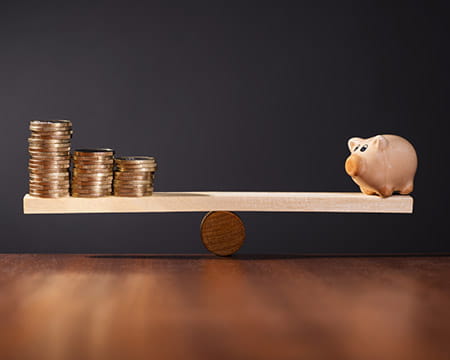 coins and a piggy bank balanced