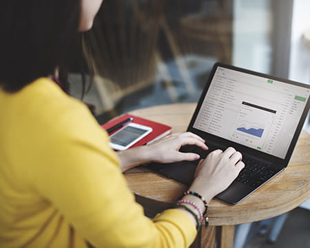 Woman on a laptop reading emails
