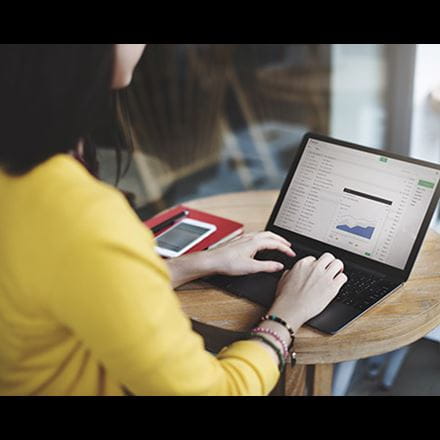 Woman on a laptop reading emails