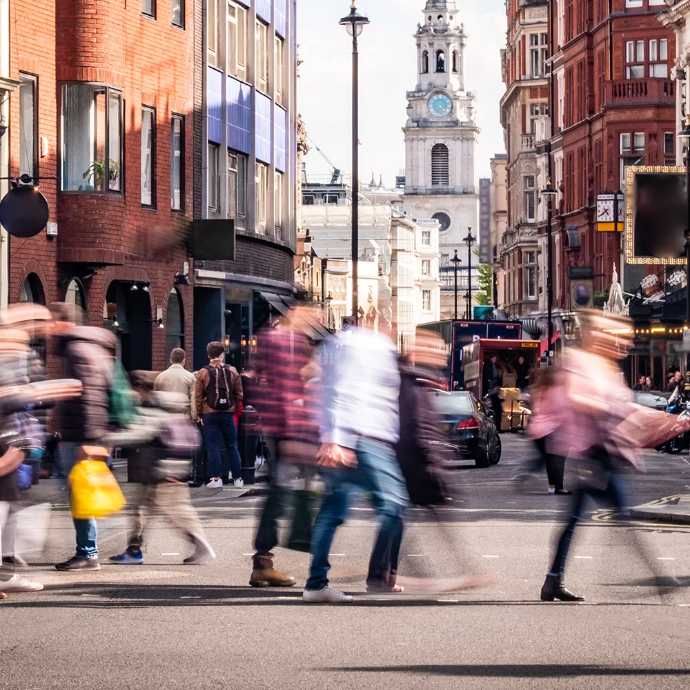 Blurred people crossing a road