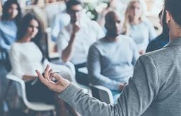 People sitting down listening to a talk