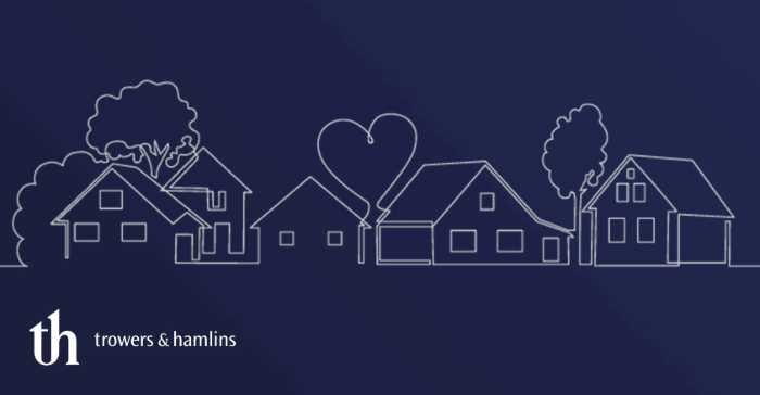 Line drawing of homes on a street with trees